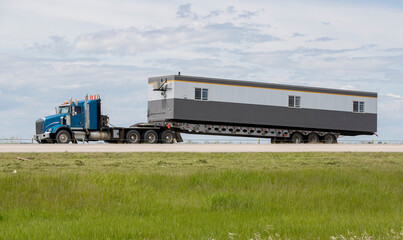 Heavy cargo on the road. A truck hauling freight along a highway. Taken in Alberta, Canada