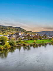 Fototapeta na wymiar Bruttig-Fankel village on moselle river bank and colourful vineyards during autumn in Cochem-Zell, Germany