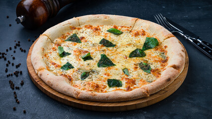 Italian kitchen pizza with cheese, greens and spices.