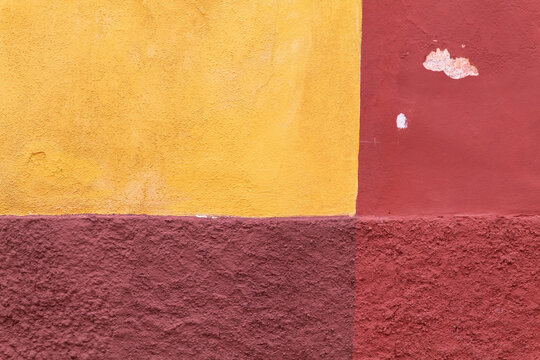 Colorful Mexican exterior wall painted in shades of off CENTERED, distressed textures