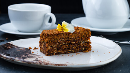 Piece of honey chocolate cake on plate.