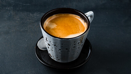 A cup of hot espresso coffee, black coffee in cup.