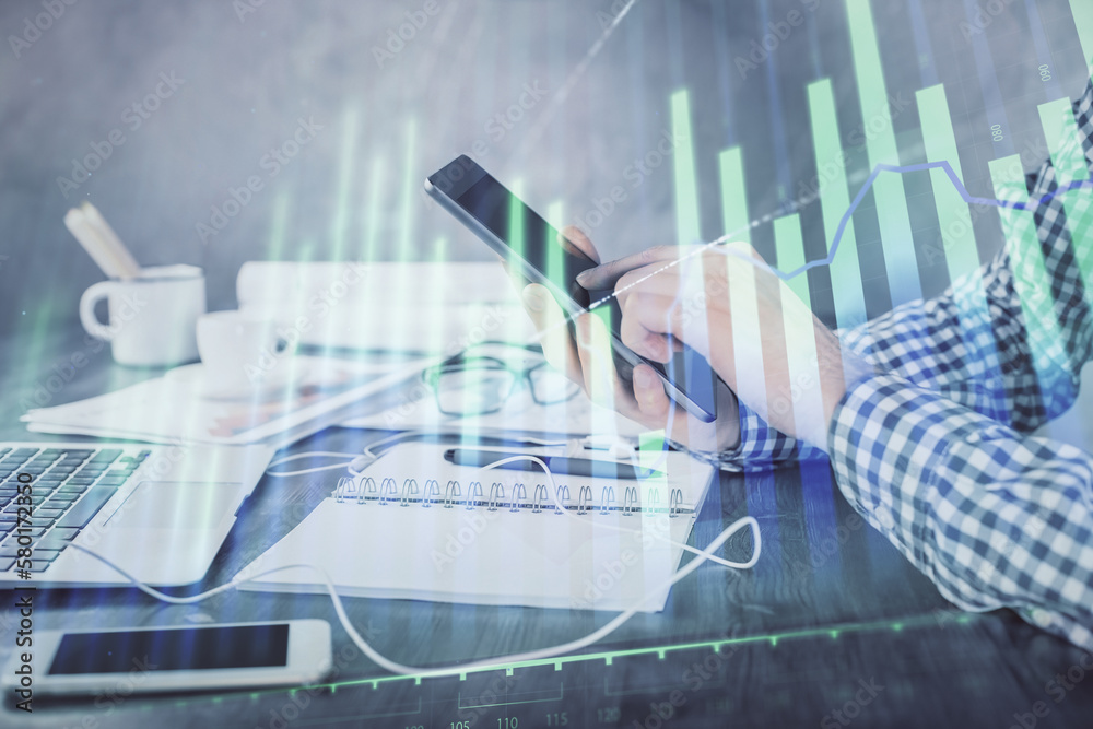 Poster double exposure of man's hands holding and using a digital device and forex graph drawing. financial