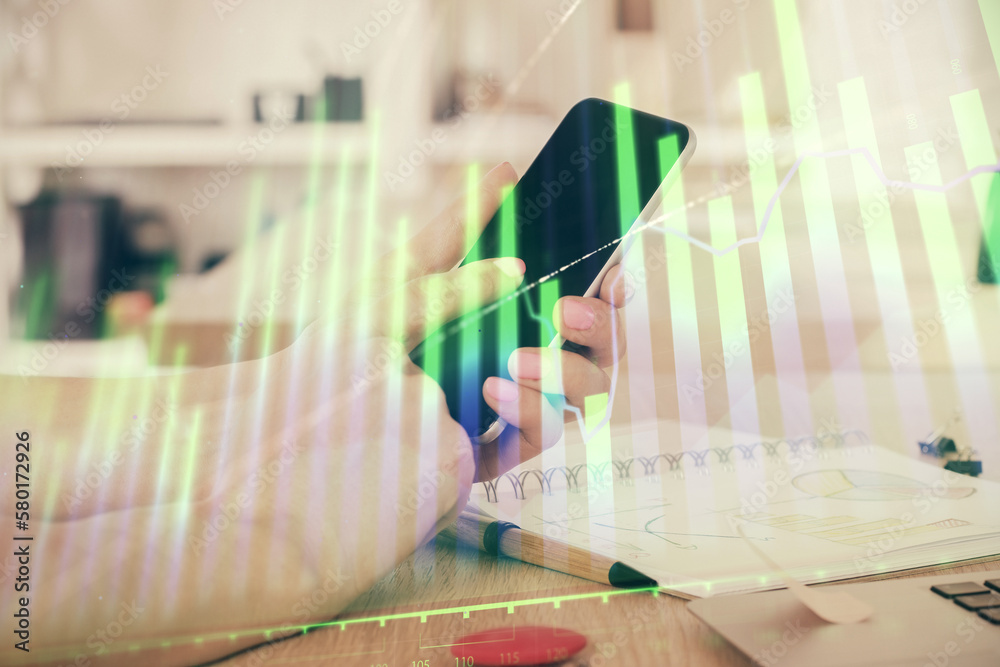 Poster double exposure of man's hands holding and using a digital device and forex graph drawing. financial