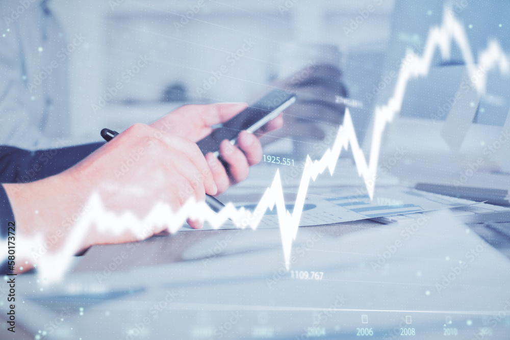 Poster double exposure of man's hands holding and using a phone and financial chart drawing. market analysi