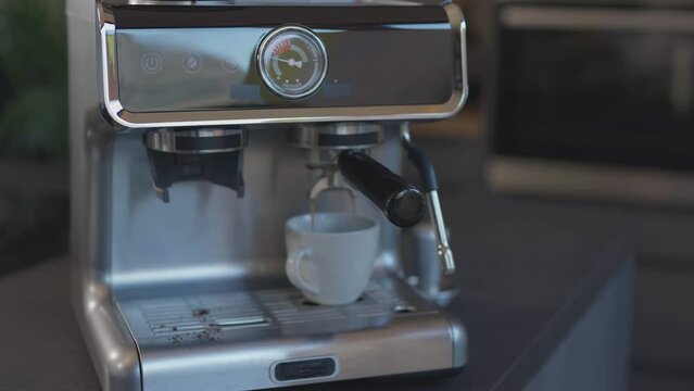Caucasian female has just prepared espresso.