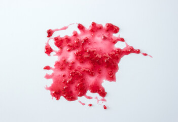 Abstract blot of raspberry jam. Berry confiture on a white background. The concept of sweet home canning. Copy space, top view
