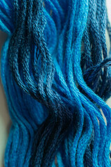 Waves of blue thread bring to mind swells of the ocean or shades storm clouds.