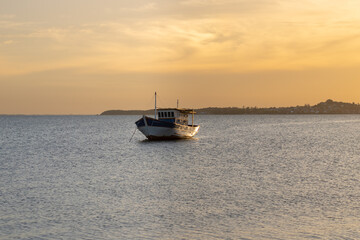 Fototapeta premium Fishing boat on the sea at sunset. Beautiful natural background.