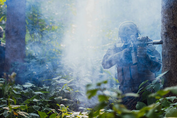 A modern warfare soldier on war duty in dense and dangerous forest areas. Dangerous military rescue...