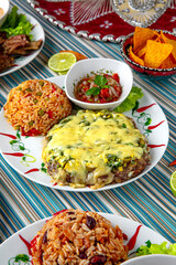 Traditional mexican food. Pork baked with cheese and garnished with spicy rice. Colorful Food Table Celebration Delicious Party Meal Concept. 