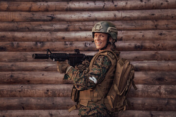 Fototapeta premium Woman soldier ready for battle wearing protective military gear and weapon