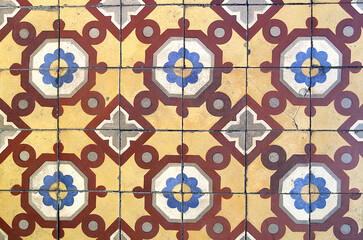 Colorful mosaic floor or wall with yellow, blue and brown tones
