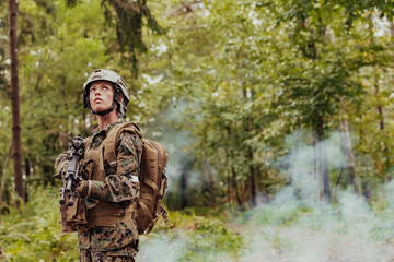 Woman soldier ready for battle wearing protective military gear and weapon