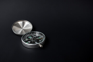 A photo of a compass on isolated black background, after some edits. © Figan
