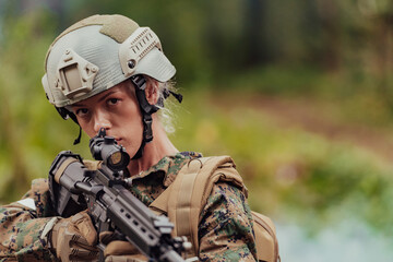 Woman soldier ready for battle wearing protective military gear and weapon