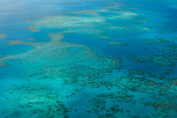 An aerial view of the coral reefs, white sand bars, tropical isles and clear turquoise waters of the Great Barrier Reef — Coral Sea, Cairns; Far North Queensland, Australia