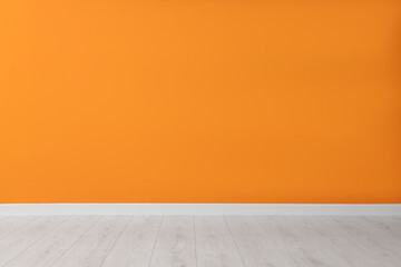 Empty room with orange wall and wooden floor - Powered by Adobe