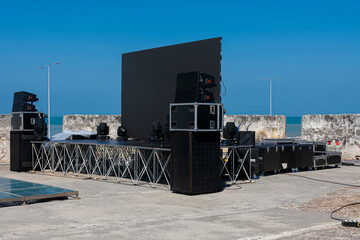 Preparation of a public event in the walled city with large speakers and sound equipment.