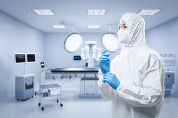 Doctor wears medical protective suit or coverall suit in surgery room