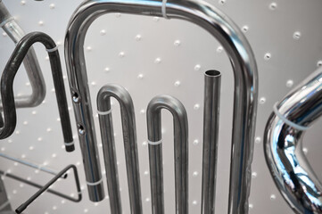 Shiny steel pipes on display in contemporary hardware store
