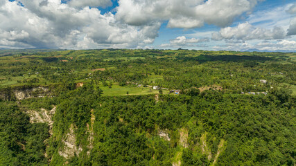 Fototapeta premium Hills and mountains with green tropical vegetation and trees in the tropics. Clifftop View. Negros, Philippines