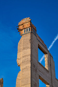 Ghost town ruins of a stone tower of an old building on a clear day.