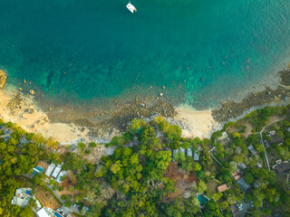 Fototapeta na wymiar aerial top view Ao Sean small white sand beach lined with rocks..turquoise sea at Ao Sane beach Phuket. 4k colorful blue sea background..beautiful nature in the hidden beach.