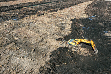 large excavator works in swampy area. drainage and meliorative works. aerial view.