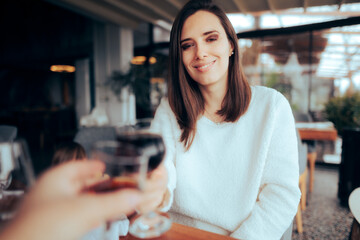 Girlfriend and Boyfriend Toasting and Celebrating on their Date. Yummy appetizing food presented in a diner shop
