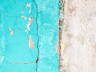 Peeling paint on the wall. Old concrete wall with cracked flaking paint. Weathered rough painted surface with patterns of cracks and peeling. Grunge texture for background and design. High resolution.