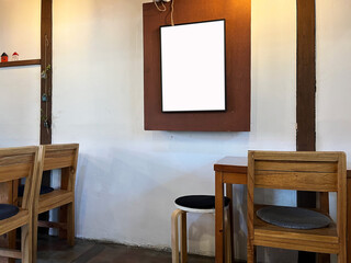 White blank frame mock up image with retro wooden table and chairs. White board mock-up in vintage cafe. 