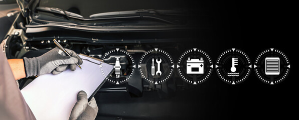 Close-up hand auto mechanic using the check list with service icons concept of repairing car engine problem and check to fix car and maintenance servicing.