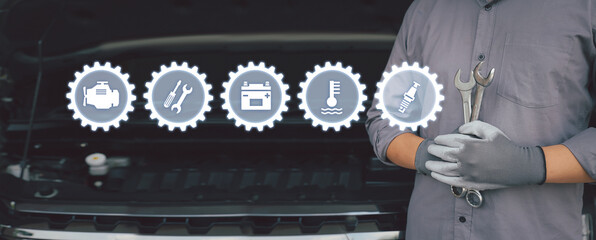 Close-up hand auto mechanic using the wrench with service icons concept of  repairing car engine...