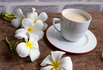 Obraz na płótnie Canvas Cup of tea with milk on wooden background