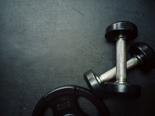 Naklejka na ściany i meble Gym equipment on dark floor background