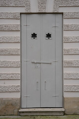 antique iron doors with forging elements in the opening of the building
