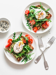 Wholegrain bread sandwiches with avocado, poached egg and arugula cherry tomatoes salad - delicious...