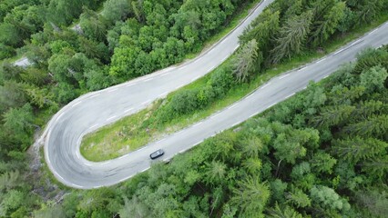 Aerial view of a winding road and forest in Norway. Picturesque mountain road
