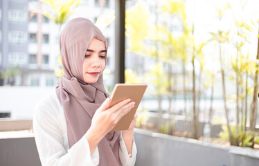 muslim female smile using a tablet