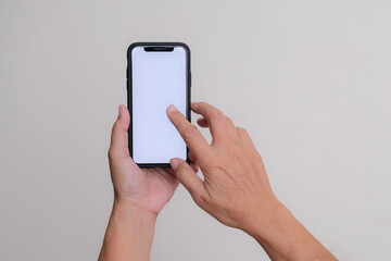 A woman’s hand holding a smartphone and touching the screen.