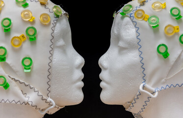 Reconstruction of the Famous fase-vase illusion, using two dummy heads and an EEG electrode cap.