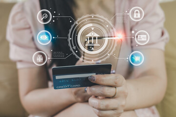 Close-up woman holding smartphone and banking credit card use order online shopping product on sofa in living room. Involved in mobile shopping at home, purchasing goods or services in internet store.