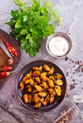 Fried mussels with onions on skewers with spice and parsley