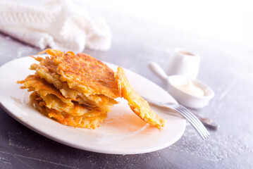Potato pancakes on white plate on a table