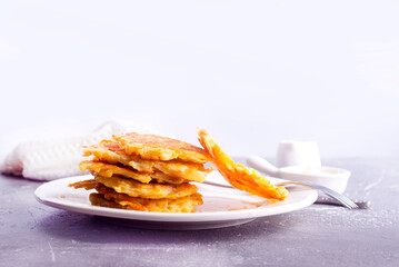 Potato pancakes on white plate on a table