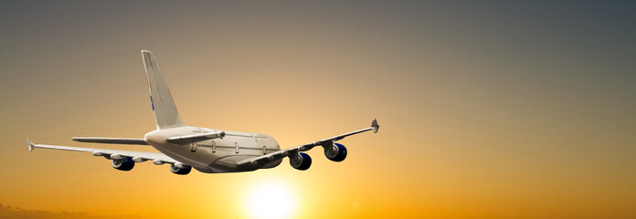Commercial airplane flying above clouds in dramatic sunset light. Very high resolution of image.