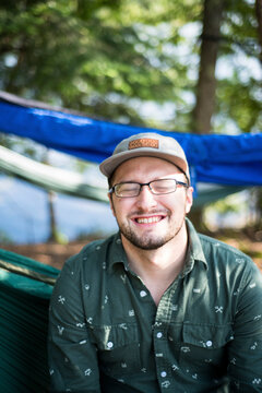 Happy man with eyes closed at campsite