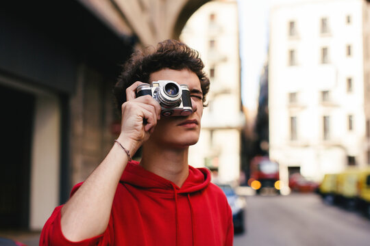 Tourist photographing with camera in city