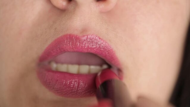 close up female lips paint with pink lipstick